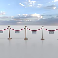 Red Rope Barriers With Gold And White Stanchions On White Floor Under Sky