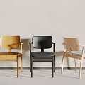 Three Dining Chairs Yellow Black And Light Wooden Against Light Colored Wall And Gray Floor