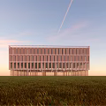 Modern Glass Building Exterior At Sunset With Cloudy Sky And Reflections