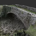 Ancient Stone Arch Bridge With Ivy Covered Walls And Gravel Ground