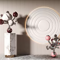Silver And White Sculptures With Red Pink Balls On Marble Pedestal And Circular Wall Decor