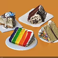 Assorted Cake Slices With Rainbow Layers Chocolate Cream And Sprinkles