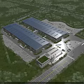 Aerial view of modern industrial factory with large metal roof surrounding greenery and parking areas