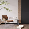 Brown Leather Leisure Chair With Metal Frame Small Round Table Green Plant And Open Book