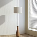 Modern Minimalist Floor Lamp With White Lampshade Wooden Base And Sunlight Shadows From Blinds