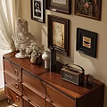 Ornamental Decor Set on Wooden Dresser with White Statue Vase Radio and Wall Paintings
