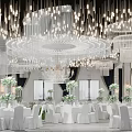 Elegant Banquet Hall With Chandeliers White Tables Green Floral Decorations And Central Flower Pathway