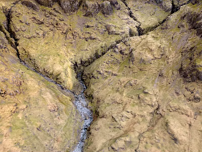 Scenic Mountainous Terrain With Flowing Stream Yellowish Green Textured Slopes And Visible Cracks 3d model