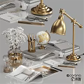 Decorative Accessories Set Featuring Gold Lamp Globe White Flowers Books And Stationery