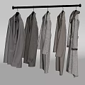 Six Different Styles of Gray Coats Hanging on Metal Hanger Light Background