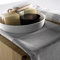 Minimalist Bathroom Accessories with White Tray Soap Black Container and Gray Towel on Wooden Surface