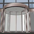 Modern Revolving Door Entrance With Glass Curtain Walls And Gray Floor Tiles