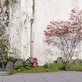 Charming Garden Ornament with Red Maple Ferns Rocks Green Grass by Weathered Wall