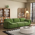 Green Velvet Three Seater Sofa In Contemporary Living Room With Wooden Bookshelf And Rattan Screen