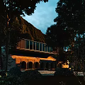 Mountain View Guesthouse Building With Modern Glass Balcony Traditional Arches And Tree Surroundings At Twilight