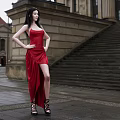Woman In Red Spaghetti Strap Top With Long Black Hair In Front Of Classical Architecture