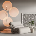 Single Sofa with Floor Lamp Circular Lampshades Black White Patterned Painting and Small Potted Plant