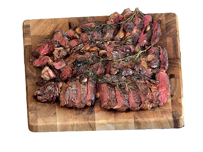 Juicy Sliced Steak on Wooden Cutting Board with Rosemary and Garlic 3d model