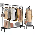 Stylish Clothes On Black Metal Rack With Shopping Bags Handbag And Hat