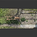 Rusty Metal Frame Equipment With Roller Standing Among Green Grass And Gravel