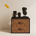 Modern Brown Nightstand With Drawers Metal Handles Green Black Containers White Candles And Black Sculpture
