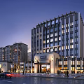 Modern Hotel Building Exterior With Illuminated Windows Entrance And Surrounding Buildings At Evening