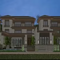 Modern Townhouse Row Exterior With Warm Evening Lighting And Landscaped Front Yard