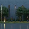 Modern Outdoor Lights Of Various Heights Illuminating Garden With Green Grass And Trees