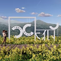 Rural Landscape Featuring Yellow Flower Field White Art Installation Mountains Blue Sky And White Clouds