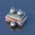 Stack of Books Featuring Three Shiny Silver Bells on Top and Beside