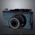 Vintage Camera With Blue Body Silver Lens And Decorative Floral Patterns