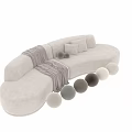 Cozy Beige Sectional Sofa With Curved Design Throw Blanket And Round Cushions