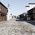 Traditional Commercial Street Featuring Stone Paved Road Wooden Architecture And Two Story Buildings