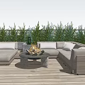 Modern Outdoor Sofa on Wooden Deck With Fire Pit Table Green Plants and Blue Sky