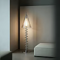 Modern Spiral Design Floor Lamp With Conical Transparent Shade Illuminated Near Light Wall