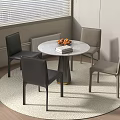 Round Dining Table With Four Black And Gray Chairs Fruits And Books On Round Rug