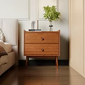 Wooden Bedside Table With Two Drawers And Vase Green Plant In Bedroom Next To Bed