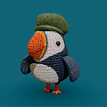 Knitted Puffin Doll With Green Hat Orange Beak Blue And White Body On Blue Background