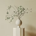 White Ceramic Vase With Green Branches And Small Berries On Pedestal Stand