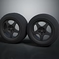 Two Black Car Tires With Alloy Wheels And Spoke Design On Dark Background