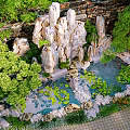Natural Garden Ornament with Rock Formations Pond Water Lilies and Lush Greenery