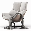 Modern Lounge Chair With Gray Cushion Beige Frame Black Base And Knitted Blanket