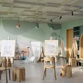 Spacious Book Art Studio With Easels Drawings Bookshelves Wooden Chairs Stools Hanging Lights Green Walls