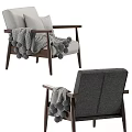 Cozy Gray Armchair With Wooden Frame Pillows And Pom Pom Blanket