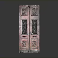 Antique Red Wooden Door With Intricate Carved Patterns And Metal Grilles