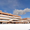 Red Brick Modern School Buildings With Classroom Structures Open Plaza Blue Sky And White Clouds