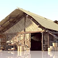 Rustic Wooden House Featuring Thatched Roof Wooden Beams Barrels And Crates