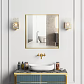 Bathroom Sink with Gold Framed Mirror Brass Faucet and Wall Sconces on White Wall