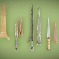 Various Decorative Knives with Diverse Blades and Handles on Green Background