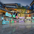 Vibrant Food Stalls In Modern Commercial Plaza With Escalator Neon Signs And Trees